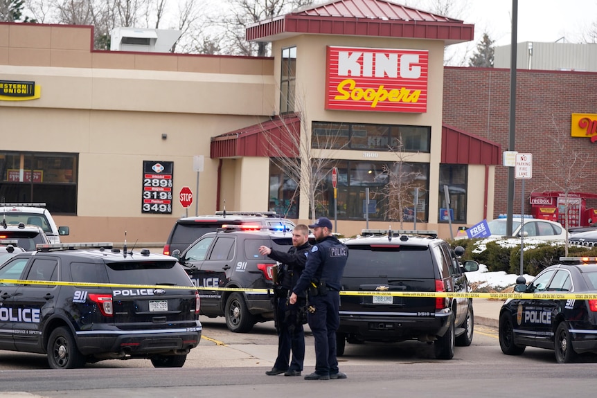 Police and police vehicles outside a King Soopers supermarket. 