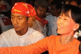 Aung San Suu Kyi shakes hands with supporters