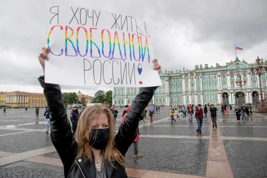 A woman holds a poster reading "I want to live in free Russia" at the Palace Square in St Petersburg, Russia.