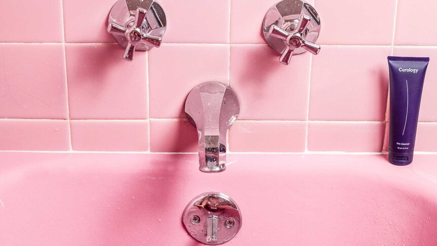 Taps over a pink bathtub