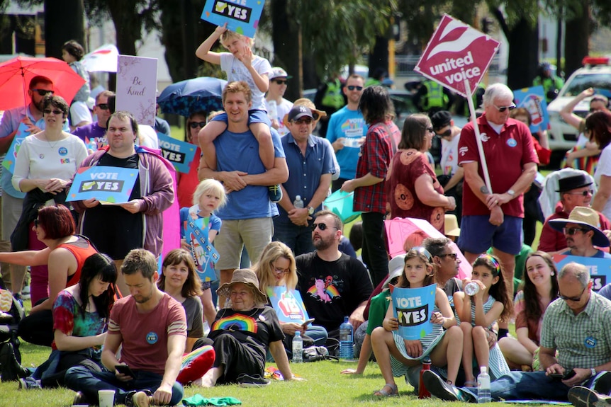 People holding yes placards.