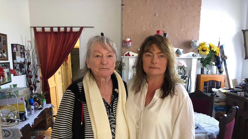 Margareth Summers and her daughter Margaret Shumack stand together in the dining room of their family home