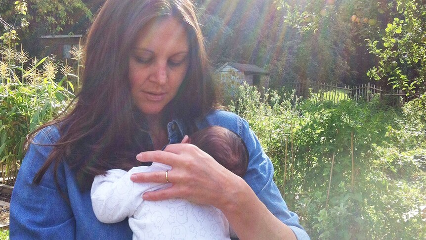 Josie Sargent holds her baby in the garden