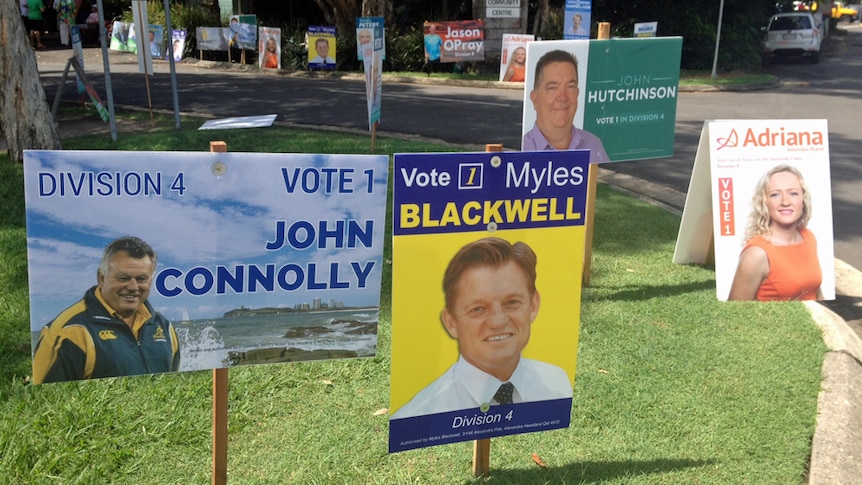 Sunshine Coast electoral placards cover the kerb at the Division 4 pre-polling booth.