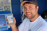 Remote irrigation monitoring system salesman Chris Connors shows off the app on his phone.