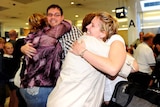 Relieved travellers hug family members as they arrive at Sydney airport
