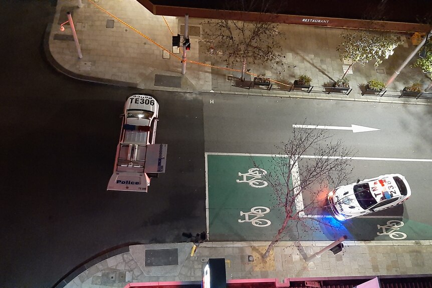 An aerial photograph of two police cars in the Perth CBD with bike lane symbols on the road.