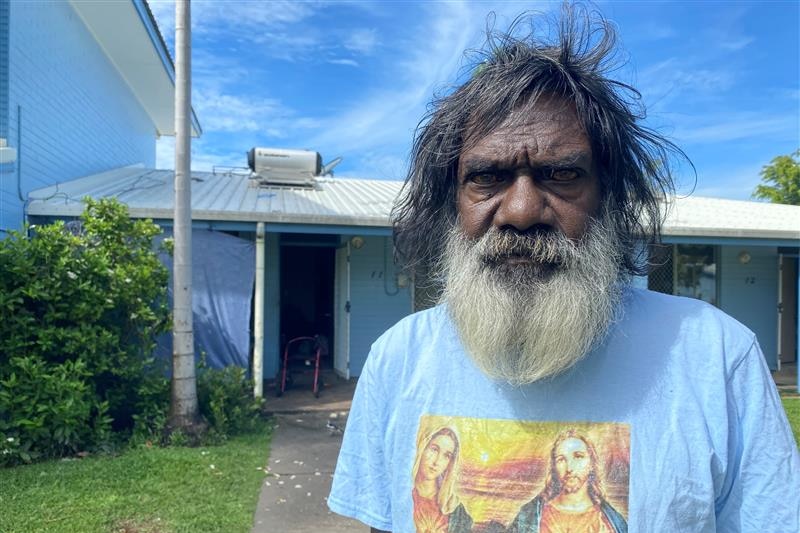 A man out the front of his public housing unit.