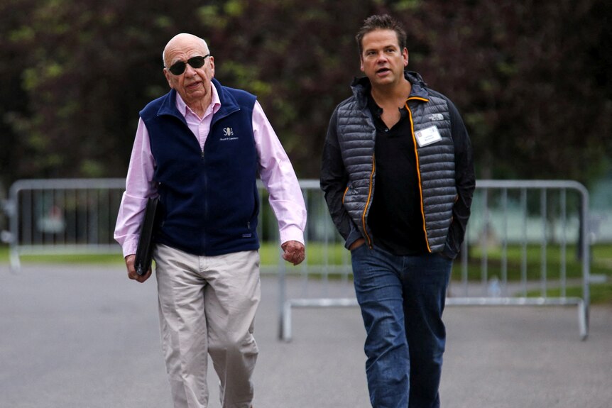 Rupert and Lachlan Murdoch walk side by side.