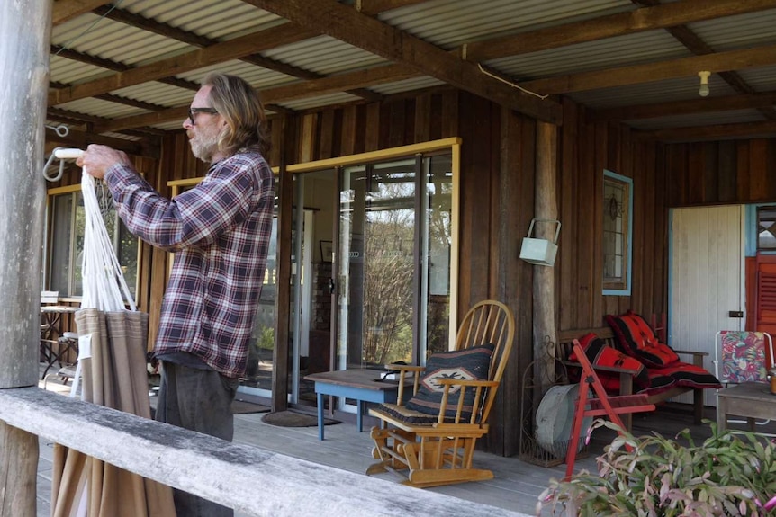 Gerard McLaughlin sets up a hammock at his cottage for short-term renters