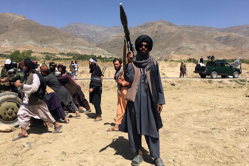 A man stands with a rocket launcher. 