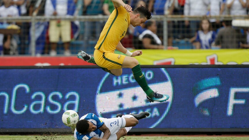 Australia's Tomi Juric jumps over Honduras' Henry Figueroa