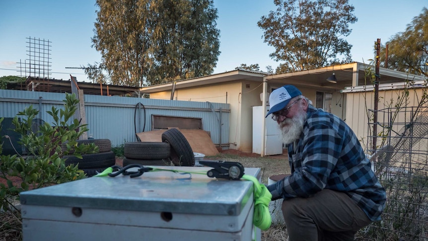 Mr Pawlaczyk with his 'foster' bee hive behind his house in Laverton, Western Australia.