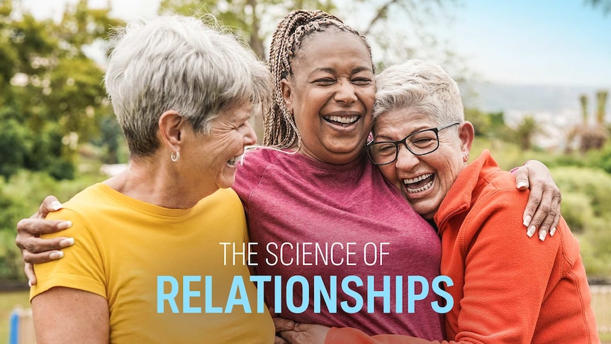 Three women embracing with big smiles in the outdoors