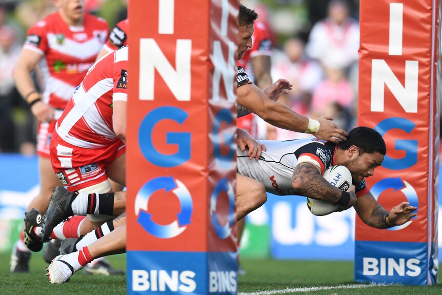 Issac Luke of the Warriors scores a try against the Dragons in Wollongong.