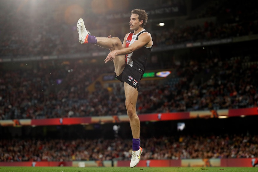 Max King is in mid-air just after making contact with a kick for goal