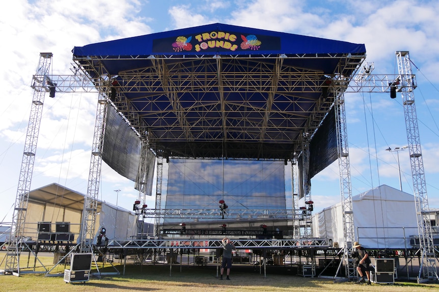 An large empty stage with a sign reading 'Tropic Sounds'