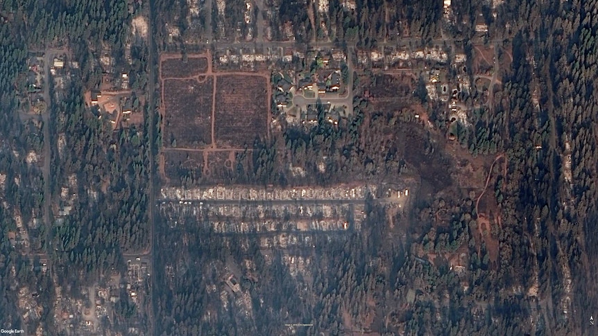 A satellite image shows the burnt-out remains of the Ridgewood Mobile Home Park.