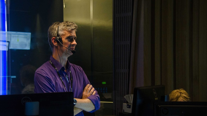 Eric Napper wearing headphones in control room.