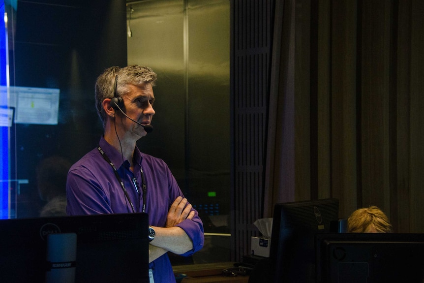 Eric Napper wearing headphones in control room.