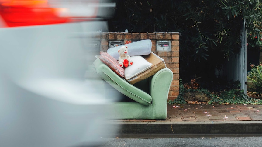 Sofa and teddy bear placed on the street for collection