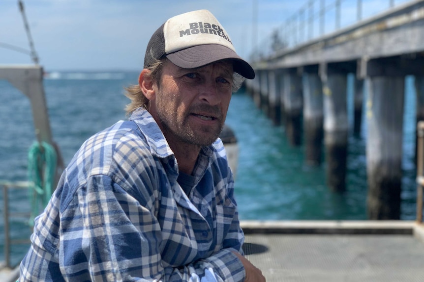 Michael Harris on a jetty with water in the background.