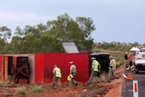 Northern Territory police inspect the scene of a Greyhound bus rollover on the Stuart Highway