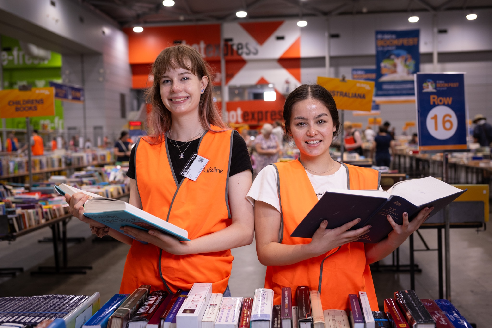 Two young women holding books
