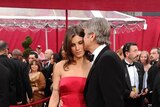 Elisabetta Canalis and George Clooney arrive at the Academy Awards