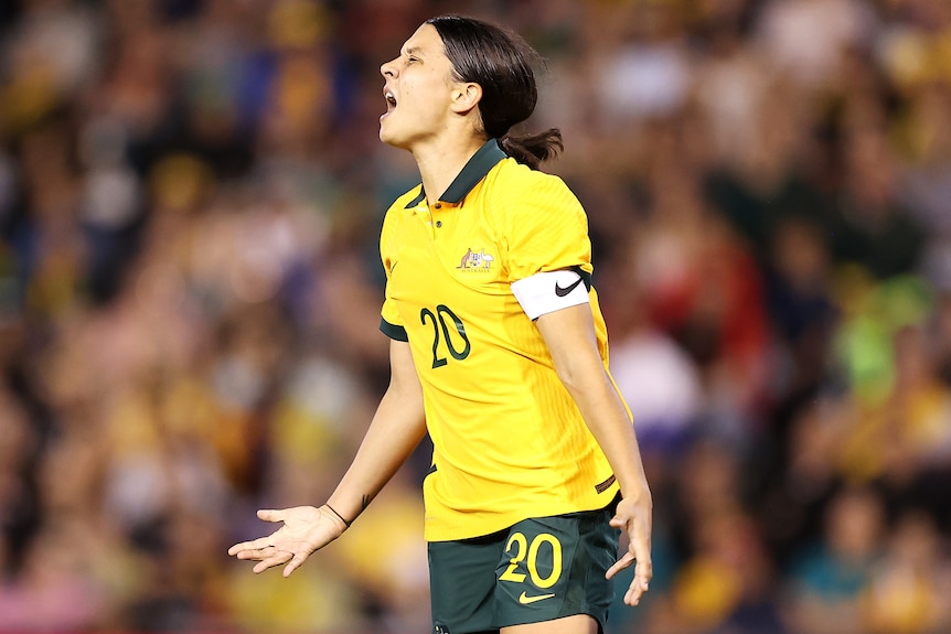 A Matildas player closes her eyes in frustration against the USA.