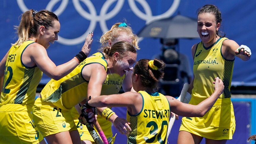 Australian hockey players celebrate after scoring a goal at the Tokyo Olympics.