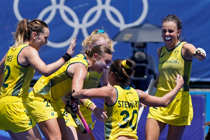 Australian hockey players celebrate after scoring a goal at the Tokyo Olympics.