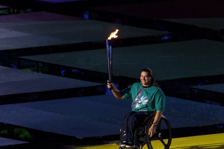 A woman lights the flame for the Paralympic games
