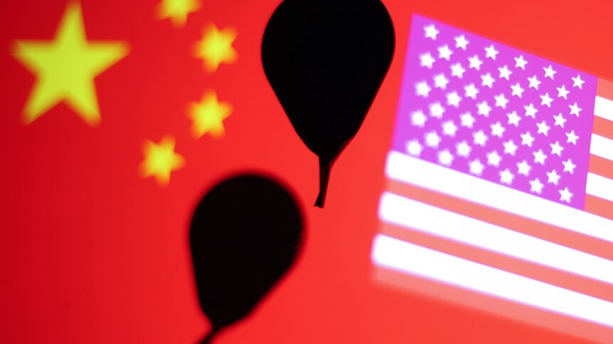 Balloon floats in front of US and China flag