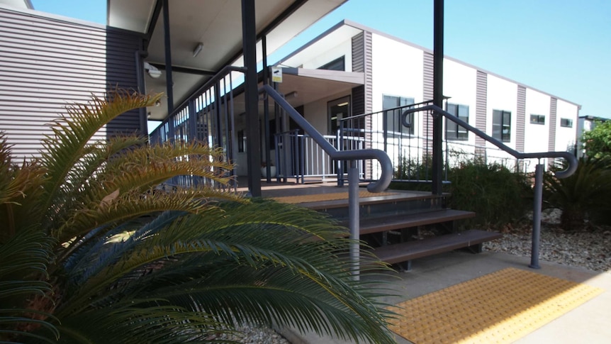 A close-up of steps leading into a new building. It is workers accomidation.