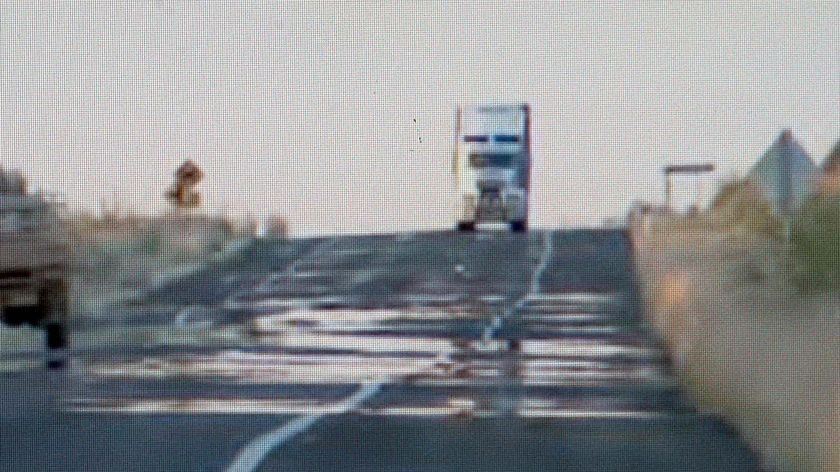 A truck makes its way along an outback highway