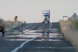 A truck makes its way along an outback highway