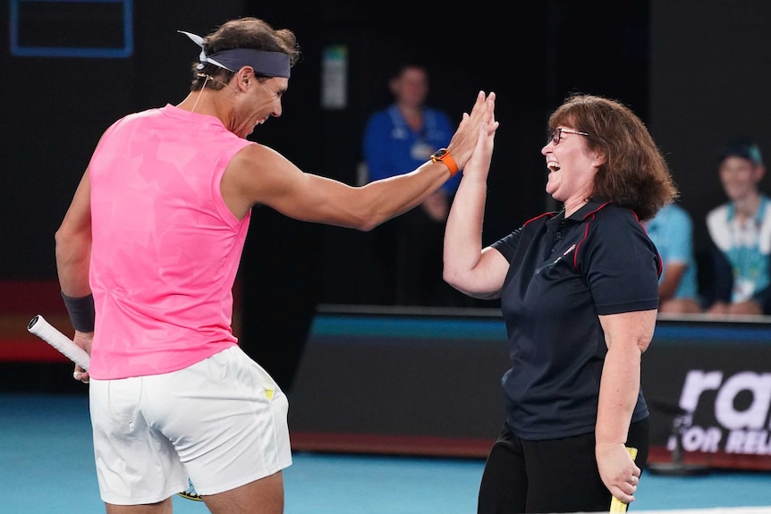 Rafael Nadal high-fives Deb Boirg at the Australian Open's Rally For Relief.