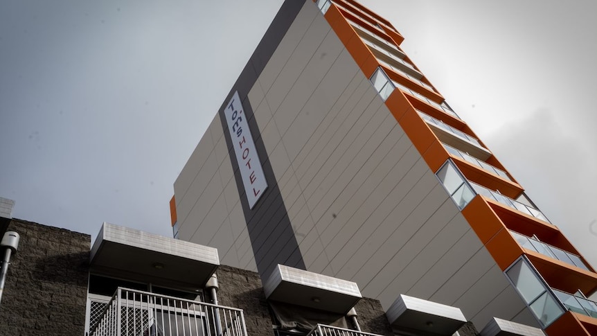 A view looking up to a multi-storey hotel called Tom's Court