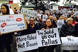 Werribee South Protesters hold "More police not prisons" and "You sold us out Pallas" signs.