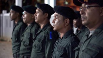 A row of Aceh Sharia police stand in a line.