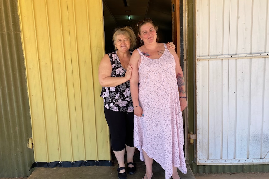 Two women standing together and smiling