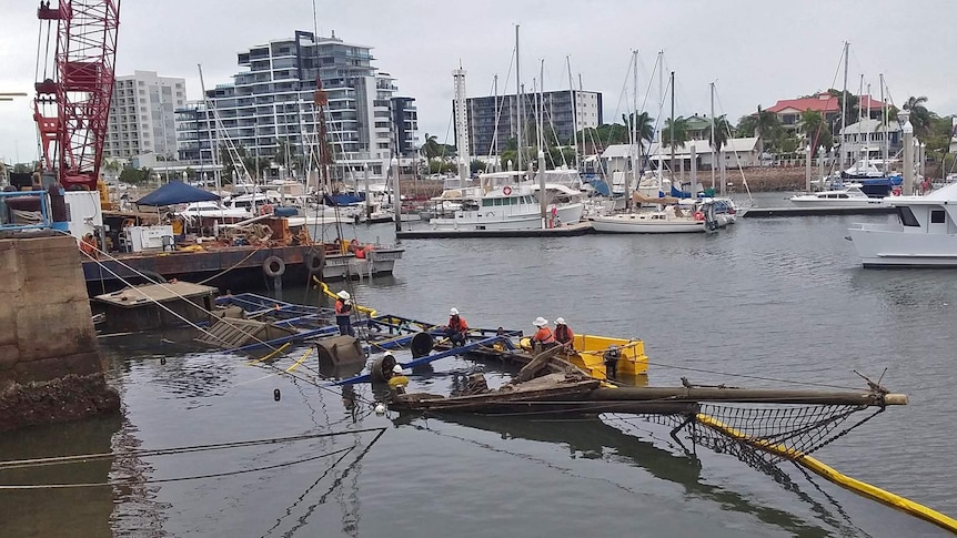 A salvage crew construct a metal frame around the wooden ship Defender ahead of its re-floating and salvage.