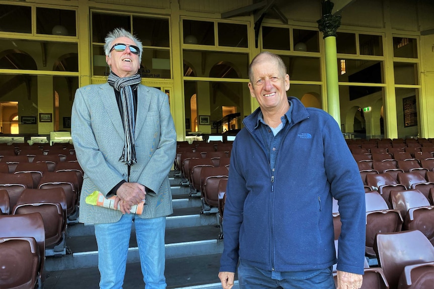 John Doyle and Greig Pickhaver stand in the Sydney Cricket Ground stands, smiling