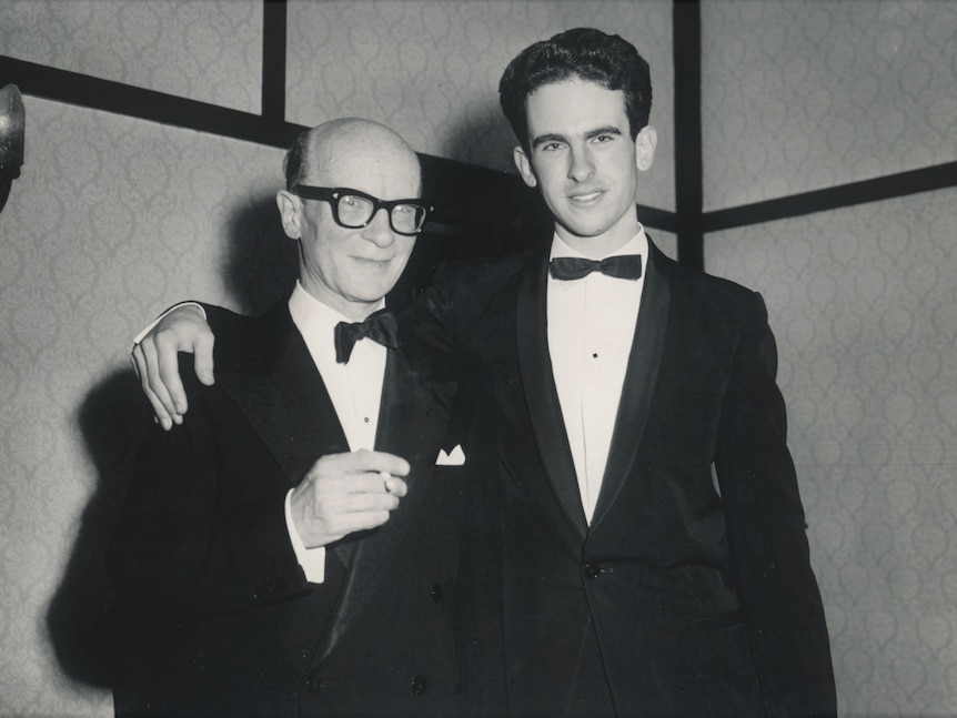 Australian pianist Roger Woodward with his arm around Alexander Sverjensky, who is holding a cigarette.
