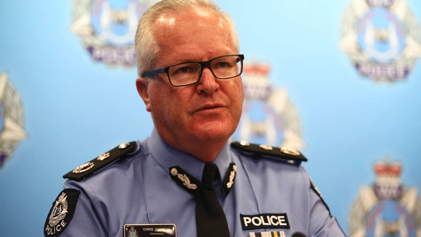 A mid shot of WA Police Commissioner Chris Dawson speaking at an indoors media conference in uniform with spectacles on.