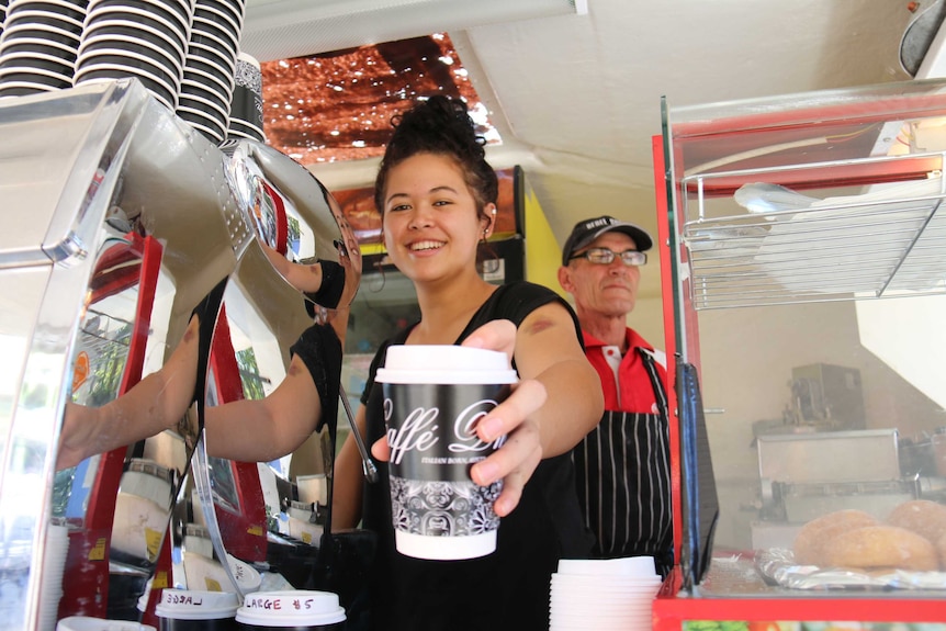 Ebony Moehau hands over coffee