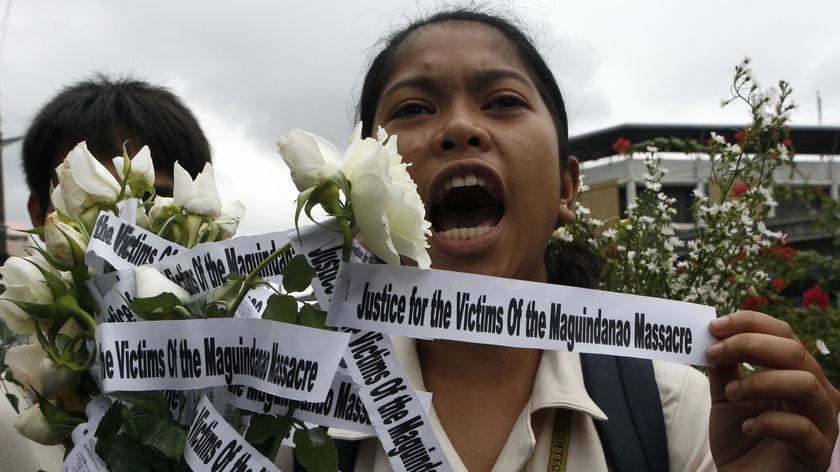 A student holds flowers for the victims of the massacre.