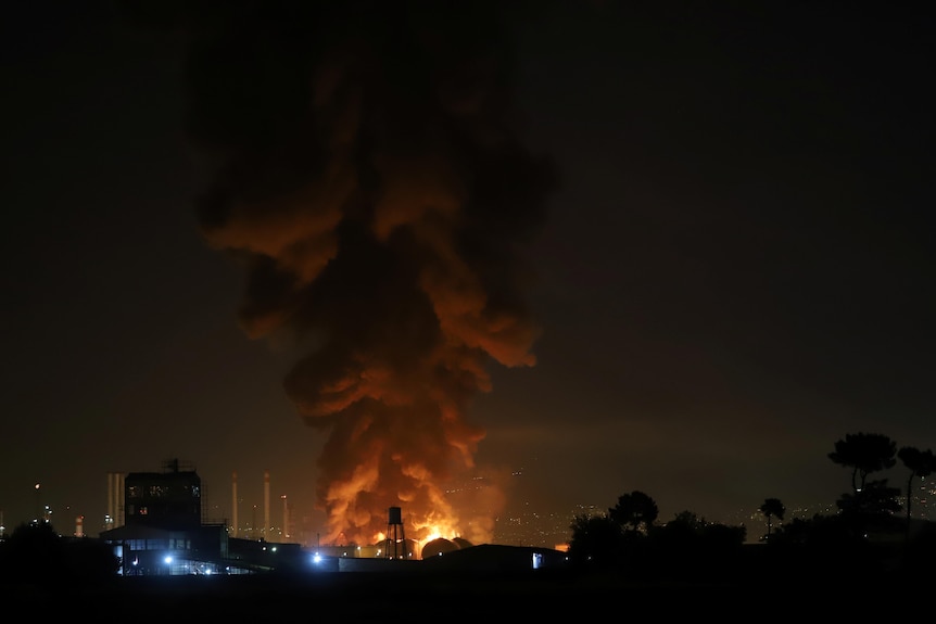 Smoke rises at an oil refinery in Tehran