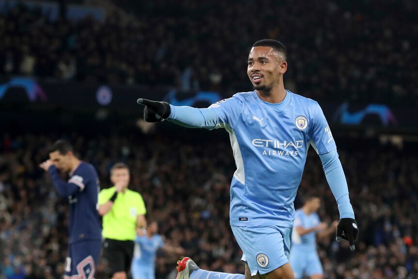 Manchester City player Gabriel Jesus points and smiles as he runs after scoring a goal Champions League goal against PSG.